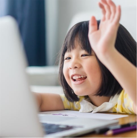 little girl raising hand looking at computer